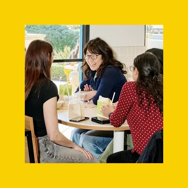 People seated at a table inside a CAVA restaurant
