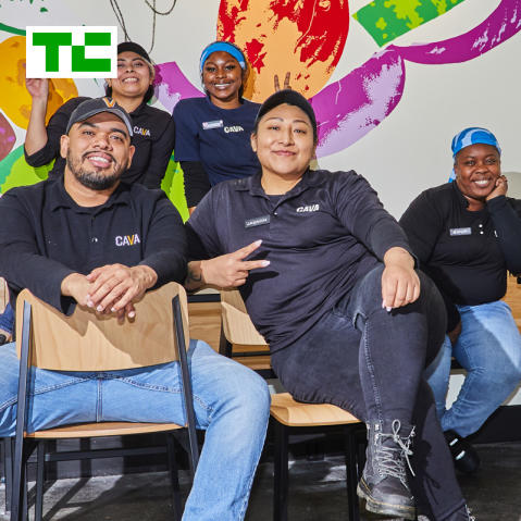 Tech Crunch logo on a photo of a group of CAVA employees