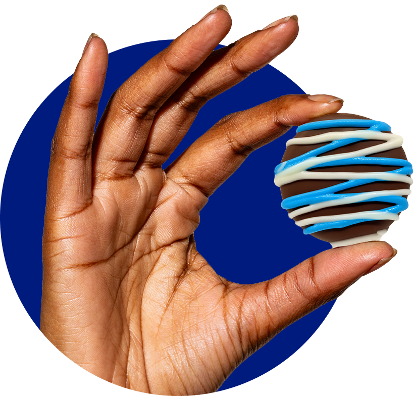 Hand holding a fudge-covered OREO cookie