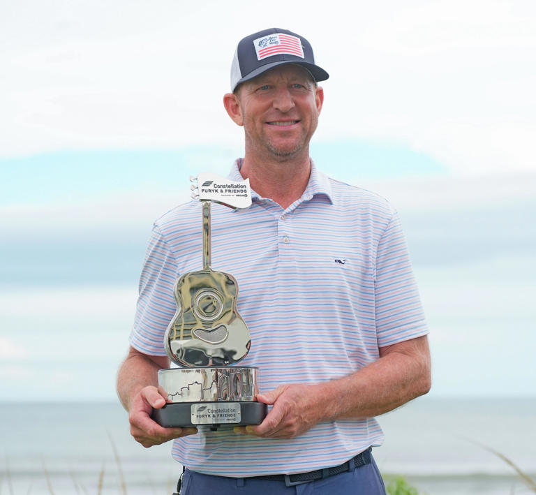 Vaughn Taylor holding the 2026 Furyk and Friends Trophy