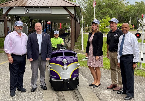 VyStar SVP, Florida Market President Lysa Barbano and staff from the Central Florida Zoo & Botanical Gardens stand near the new train engine, which is sponsored by VyStar Credit Union.