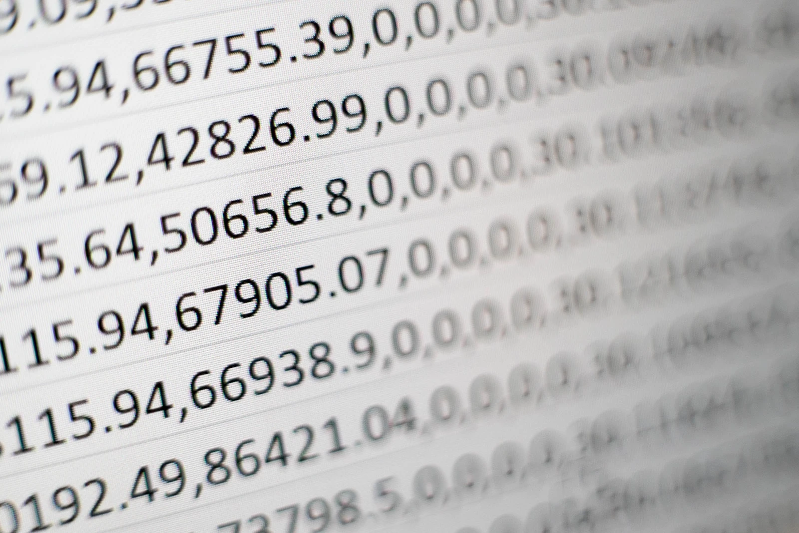 a white computer screen showing lines of a series of numbers fading out of focus