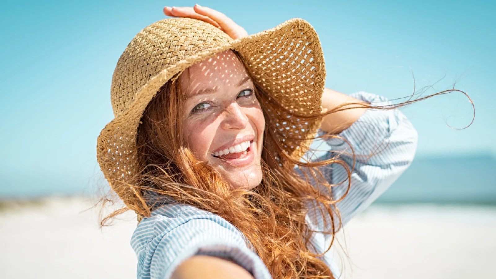 Woman with a hat smiling