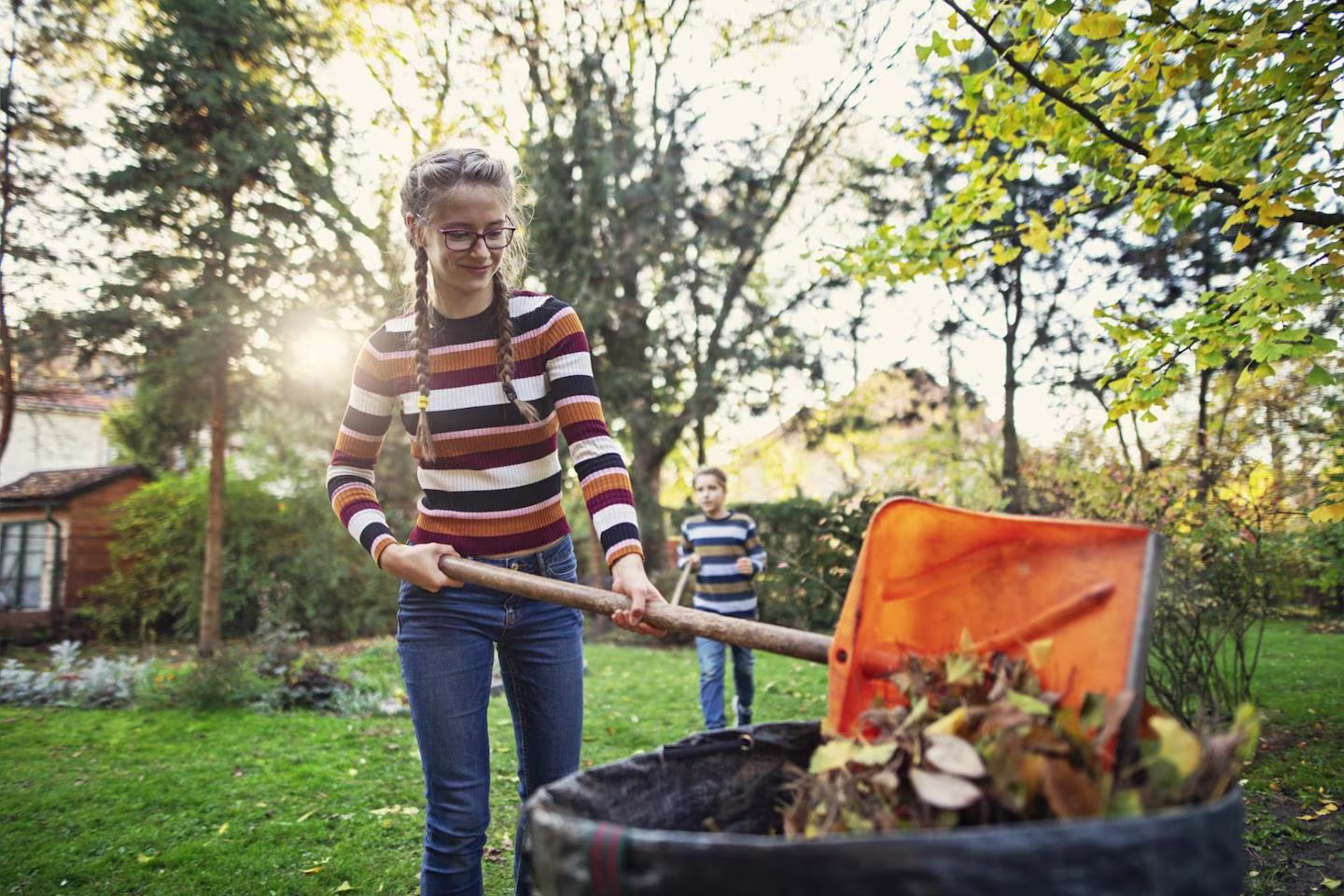 Jobs for 13 year olds: teenager cleaning their backyard