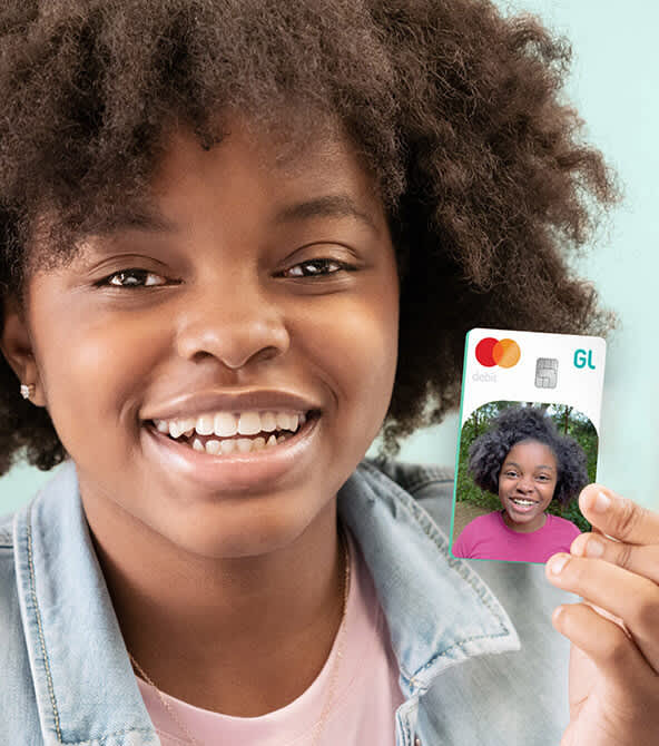 girl holding greenlight debit card