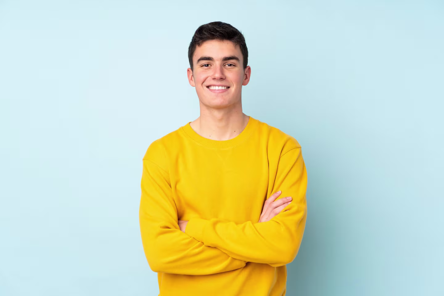 How to get a credit card for the first time: man wearing a yellow sweater