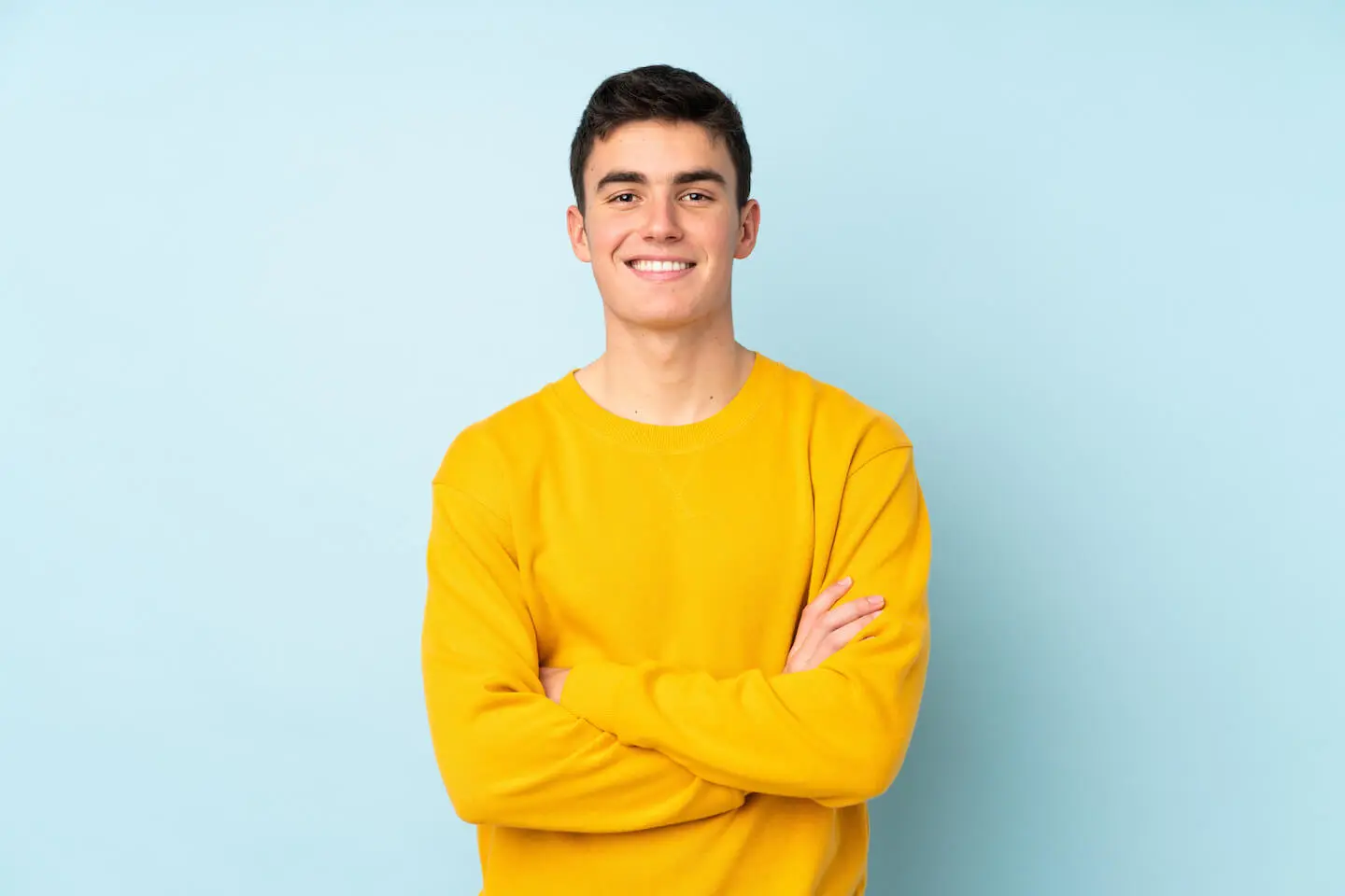 How to get a credit card for the first time: man wearing a yellow sweater