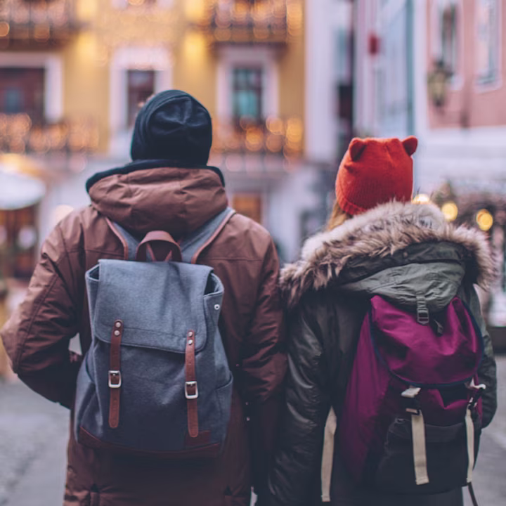 Couple traveling safely wearing backpacks and winter coats