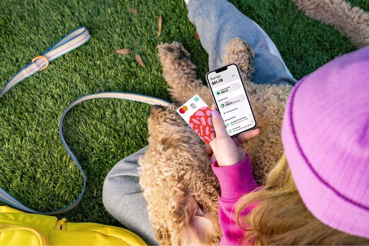 Person using her phone while her dog sleeps on her lap