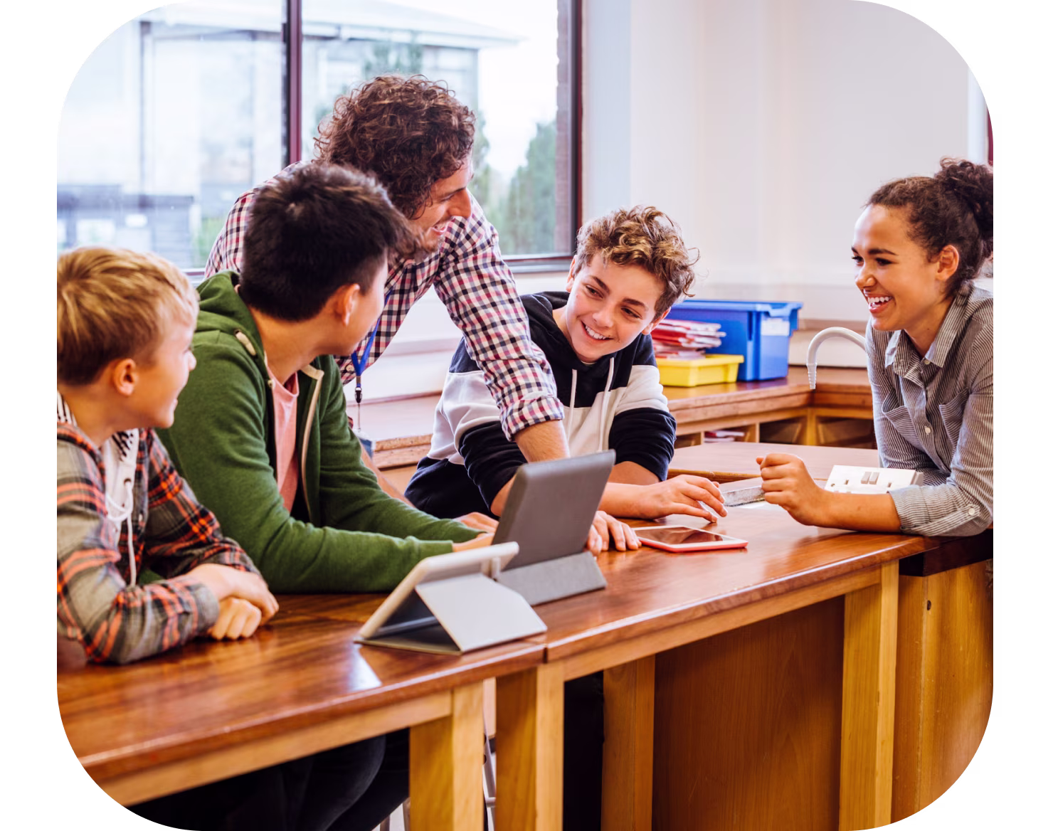 Teacher talking to students in a classroom.