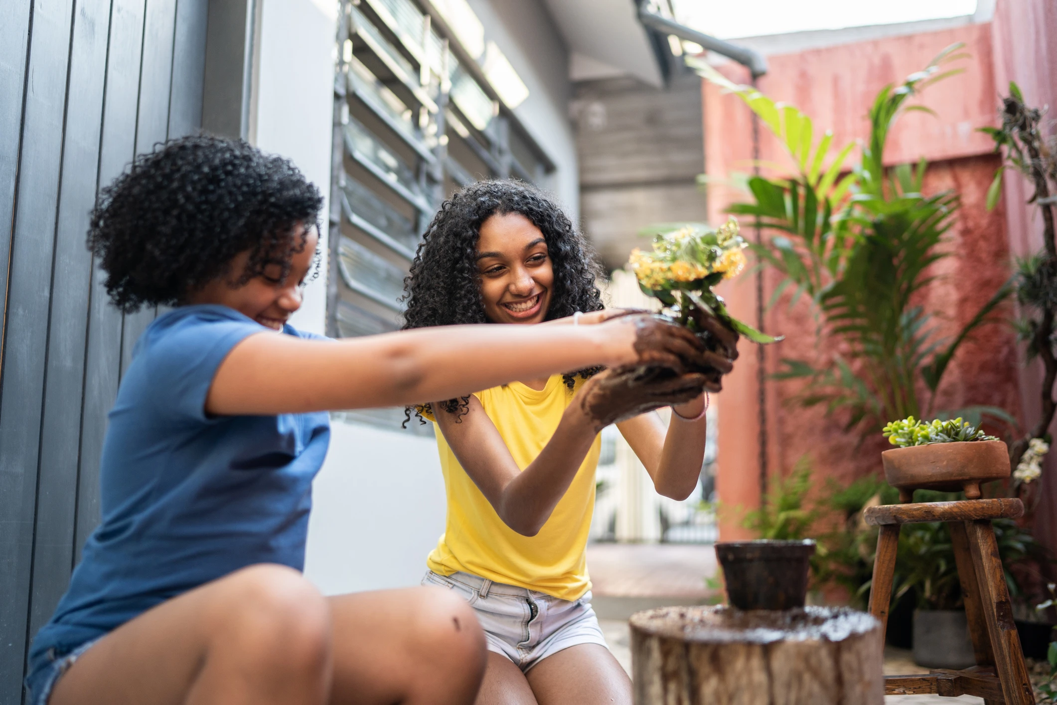 Two girls gardening outside.