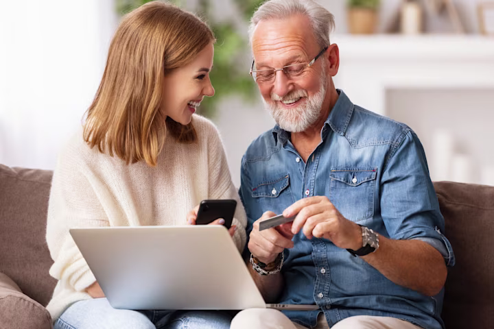 Father and daughter using their credit card online
