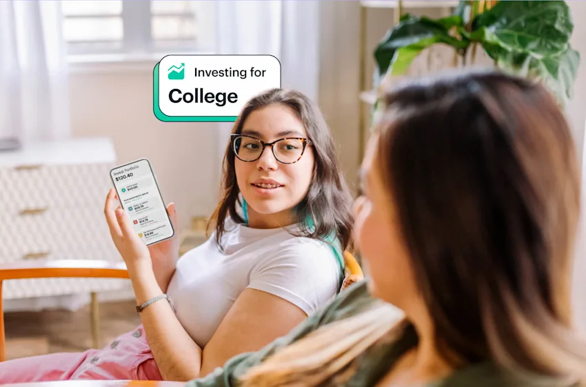 Teen girl showing mom how she's investing for college with money earned from her job with Greenlight app