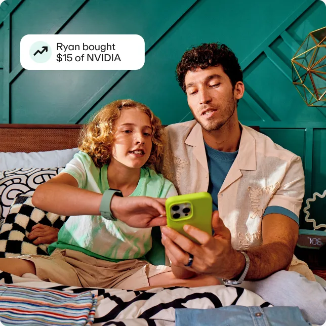 Preteen boy looking at stocks with dad