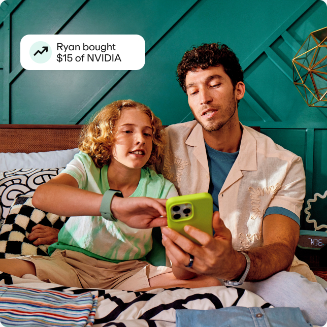 Preteen boy looking at stocks with dad