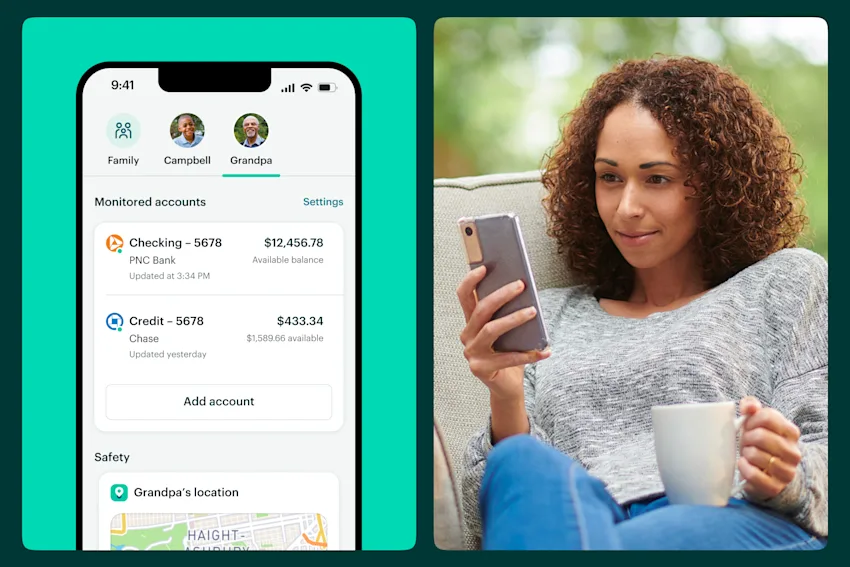 Woman looking at her Greenlight account while sitting outside and holding a mug.
