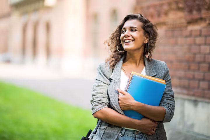How do student loans work: student carrying some files while walking