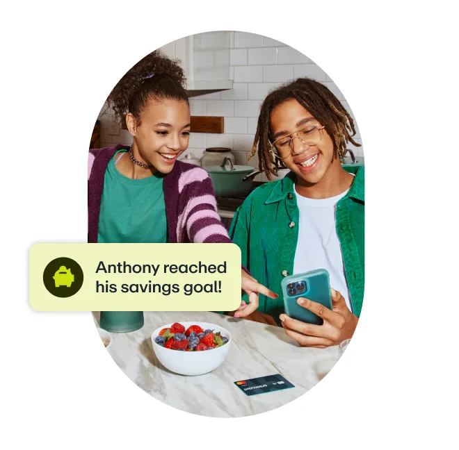 Two teens reviewing savings goal