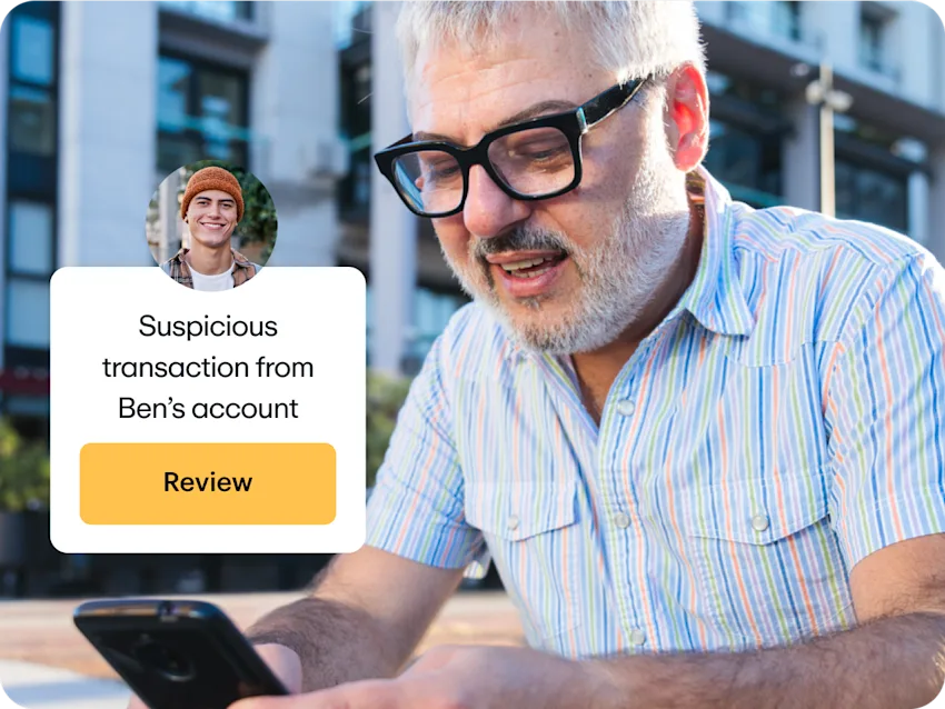 Father receiving a notification about a suspicious transaction from his son's account