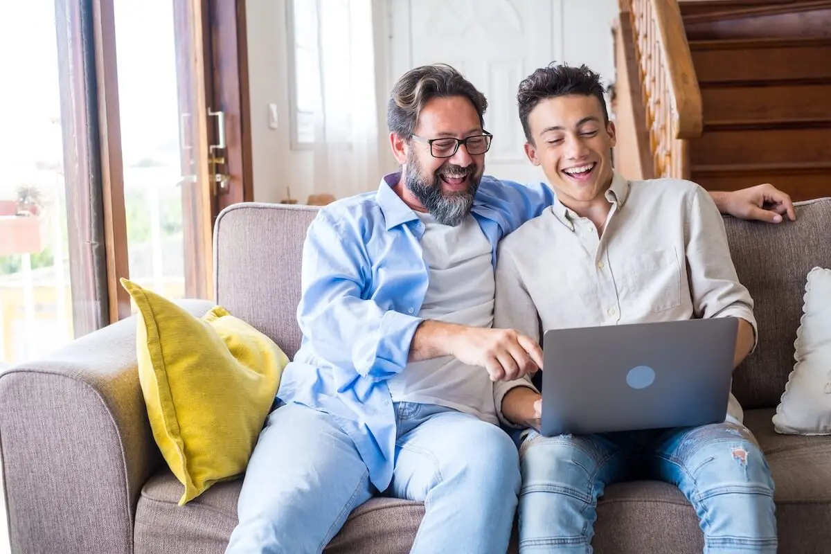 Father and son using a laptop