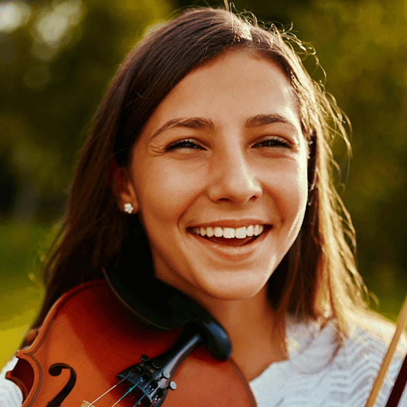 girl holding her violin