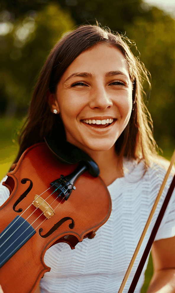 girl holding her violin