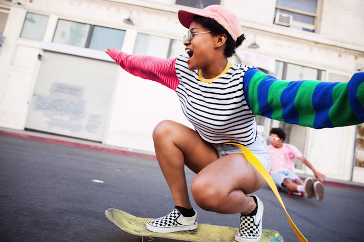 Teen racing on skateboards.