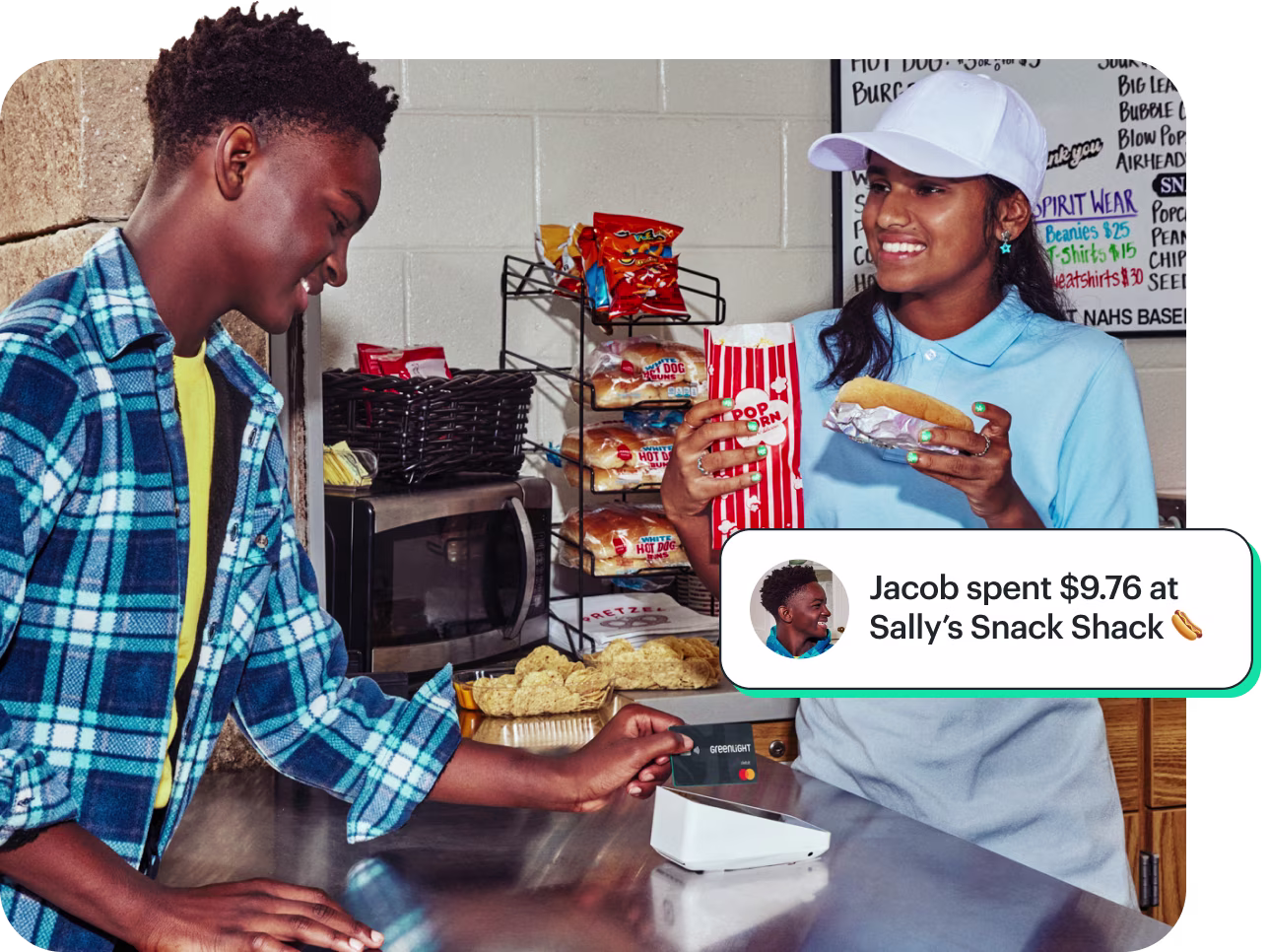 Teenage boy paying at a snack counter while a cashier hands him popcorn and a hot dog, with an overlaid notification reading 'Jacob spent $9.76 at Sally’s Snack Shack'.