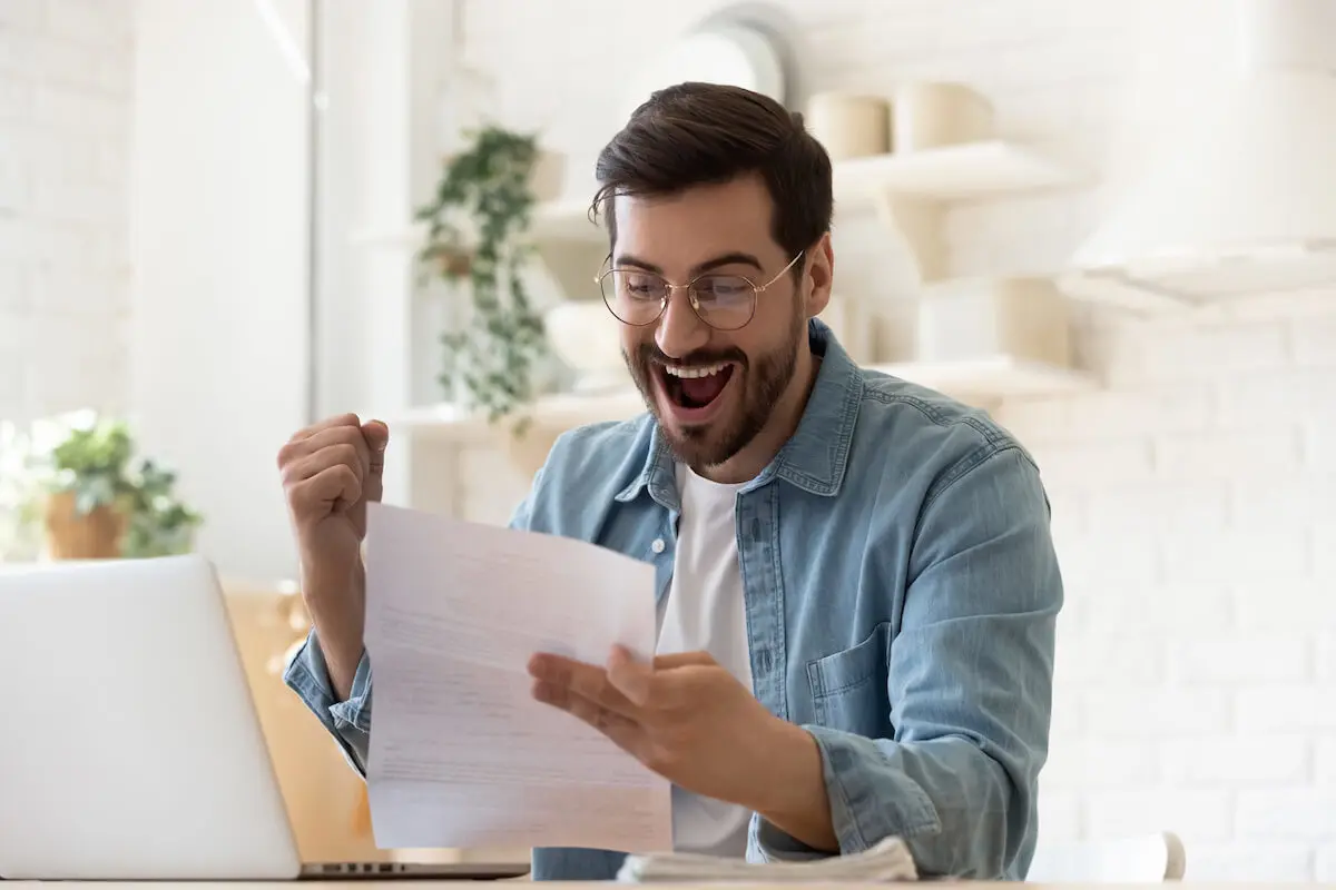 Man happily reading a document