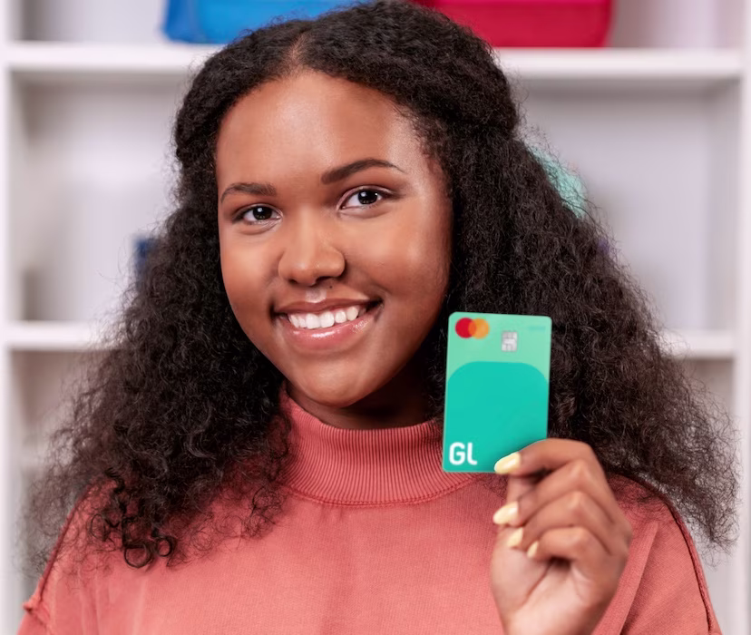 teenage girl holding a greenlight debit card