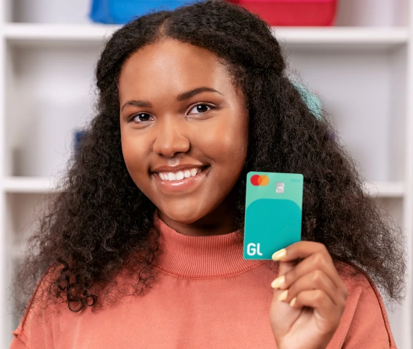 teenage girl holding a greenlight debit card