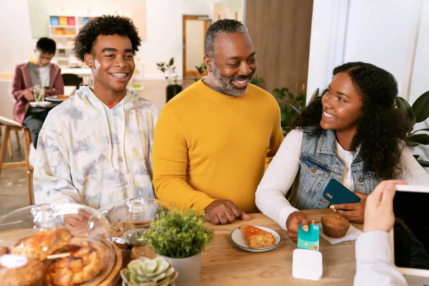 Budget categories: father and his kids buying pastries at a cafe