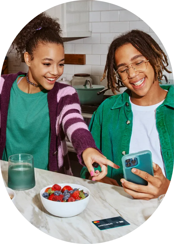 Teens reviewing a reached savings goal