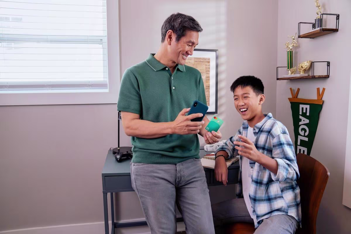 Father showing his phone to his son