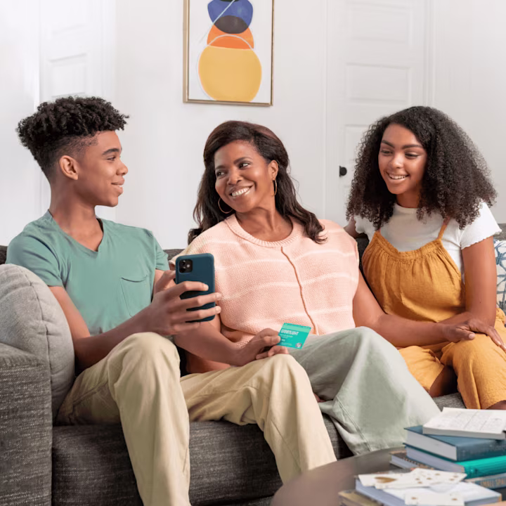 family discussing financial literacy, found within the Greenlight money app for kids

