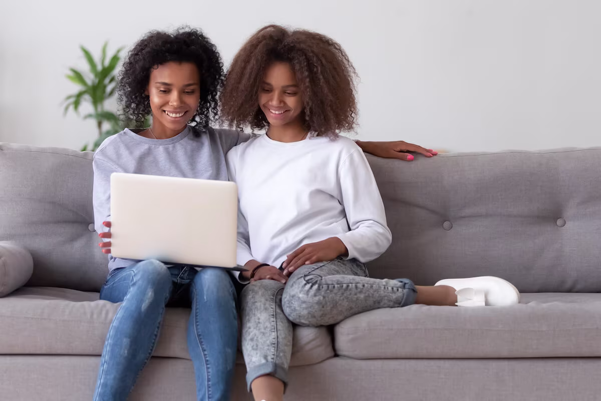 Mother and daughter looking at laptop