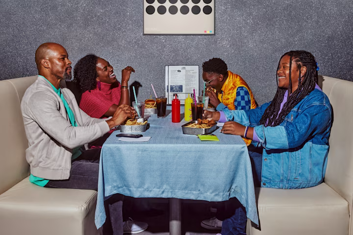 Family eating in a booth at a restaurant.