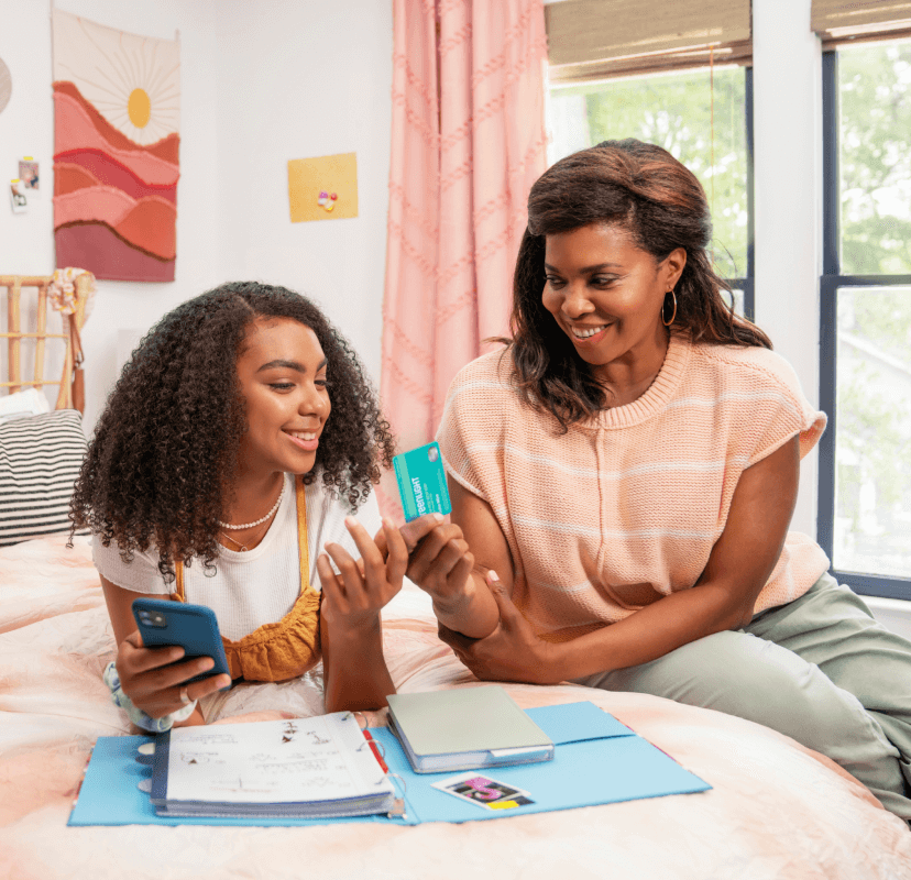 mother and daughter discussing Greenlight’s debit card for teens
