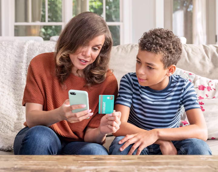 mother and son with his greenlight debit card