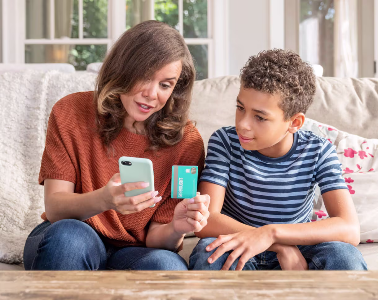 mother and son with his greenlight debit card