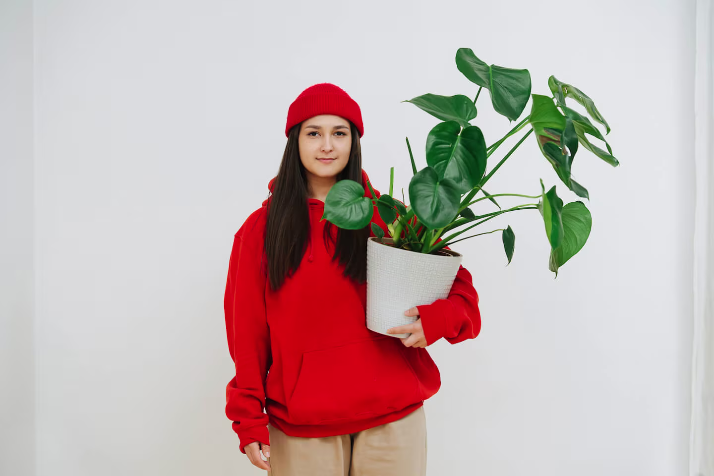 Earth Day activities for kids: woman carrying a potted plant