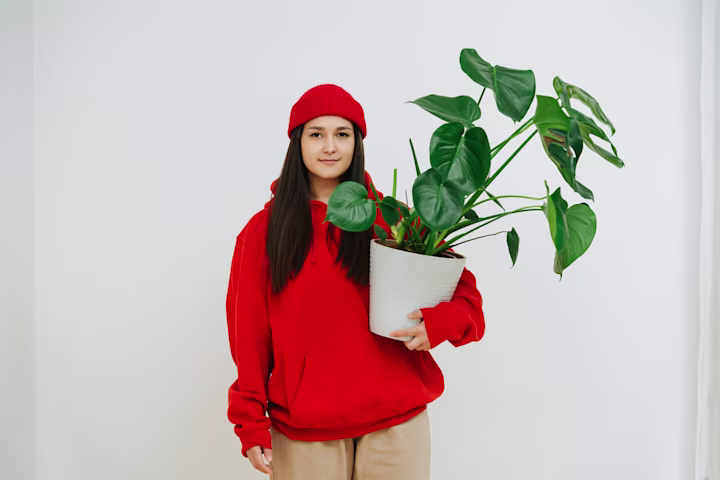 Earth Day activities for kids: woman carrying a potted plant