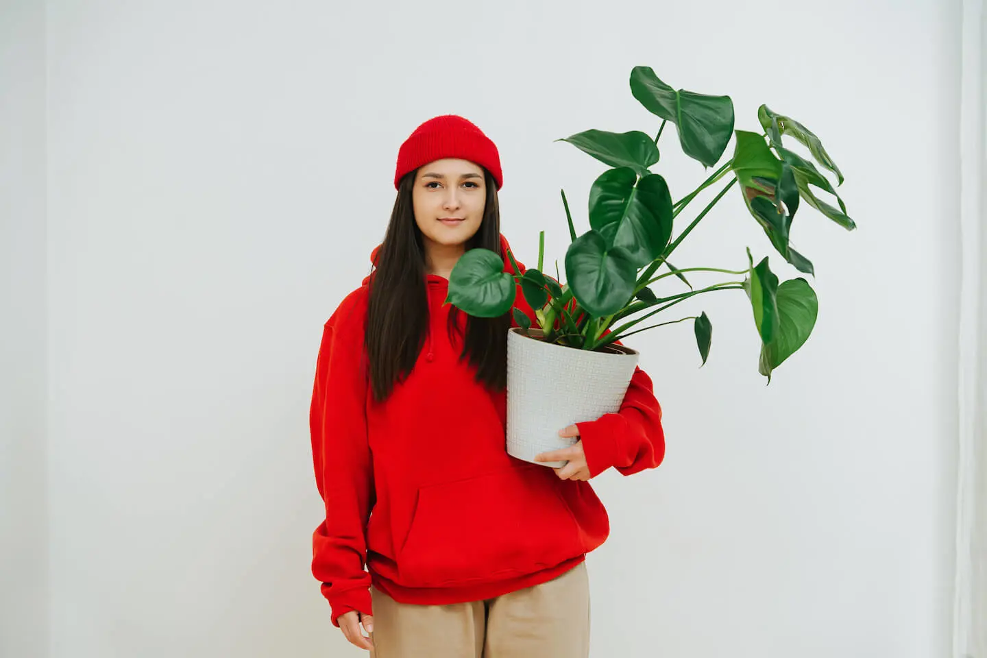 Earth Day activities for kids: woman carrying a potted plant