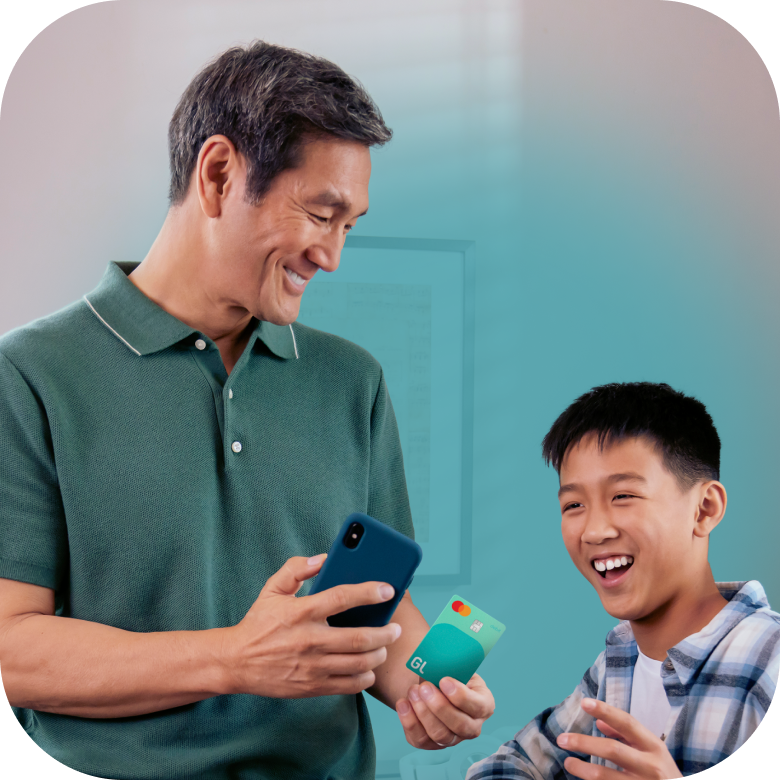 Father showing son Greenlight card and app