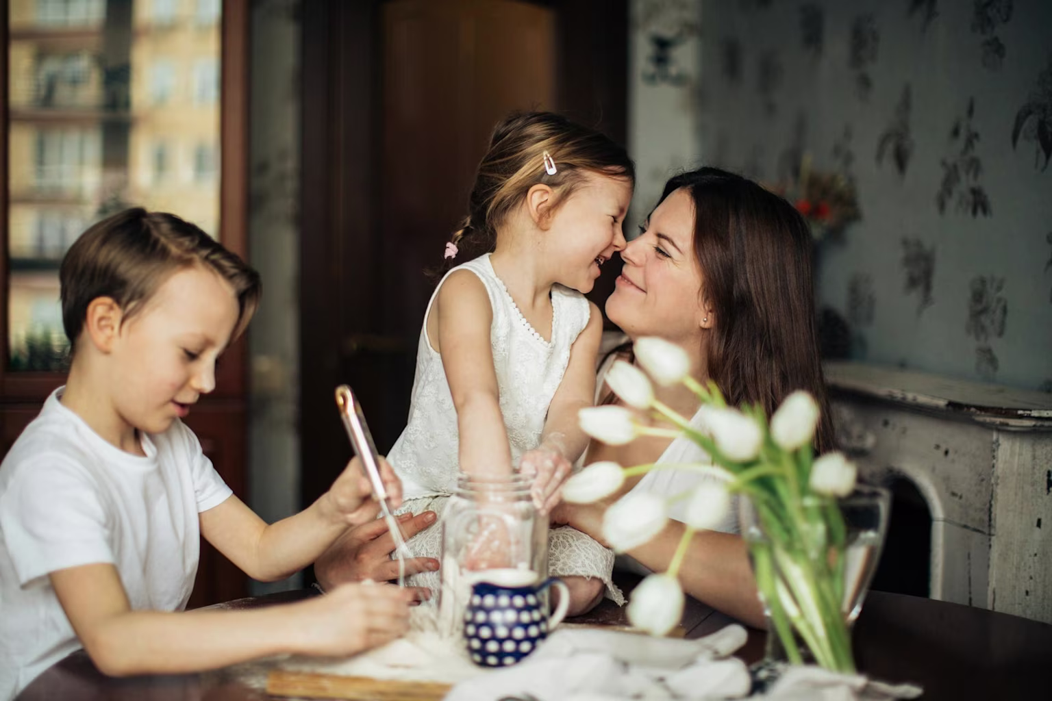 A mother and her kids at the table.