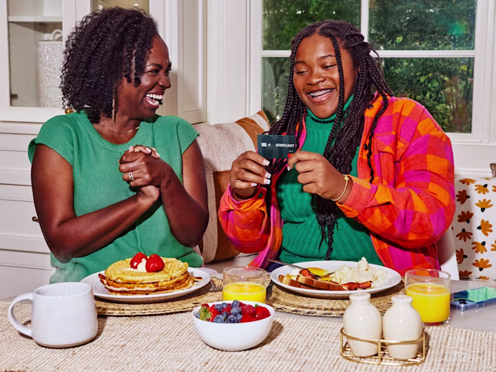 Mother and daughter having breakfast together