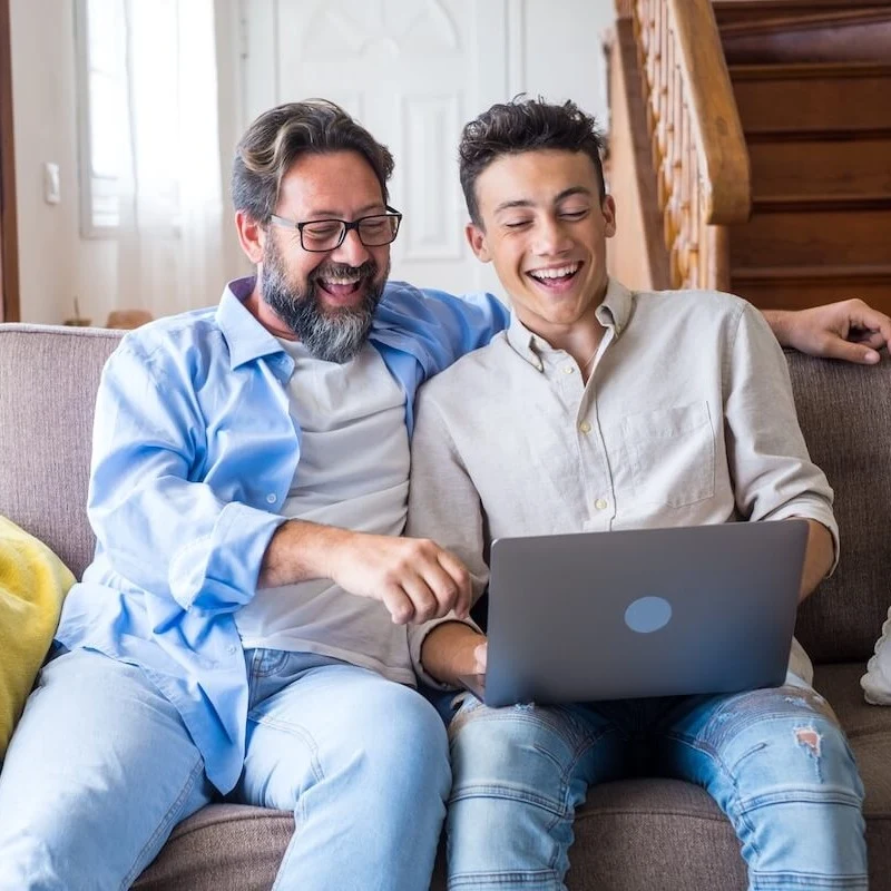 Father and son using a laptop