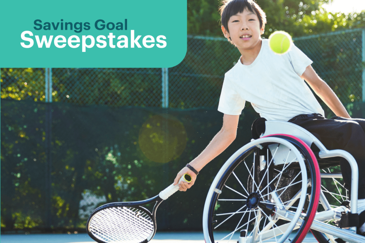 young boy in a wheelchair playing tennis