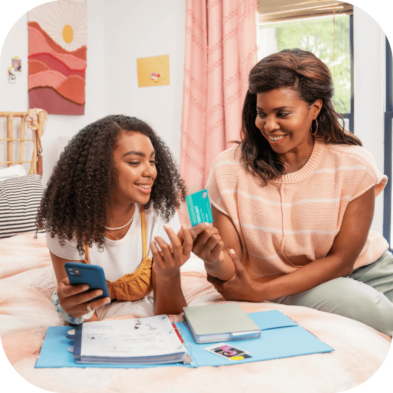 mother and daughter discussing Greenlight’s debit card for teens
