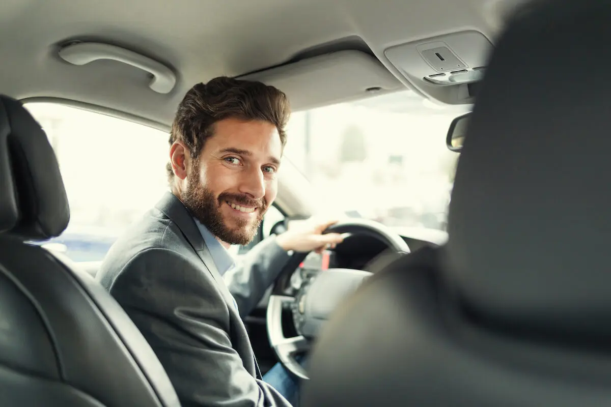 How to diversify your income: man happily driving a car